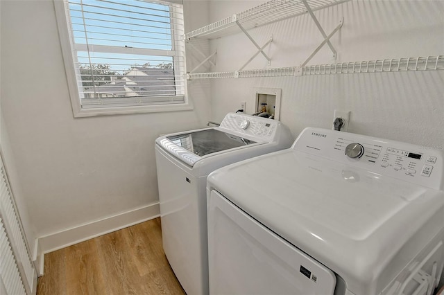 laundry area featuring washer and dryer and light wood-type flooring