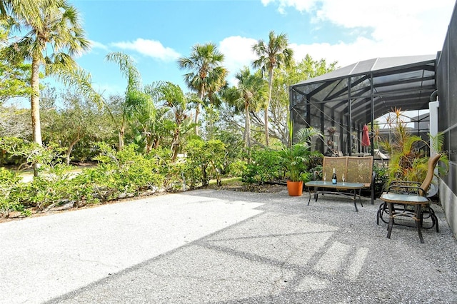 view of patio with glass enclosure