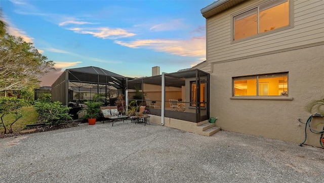 patio terrace at dusk with glass enclosure