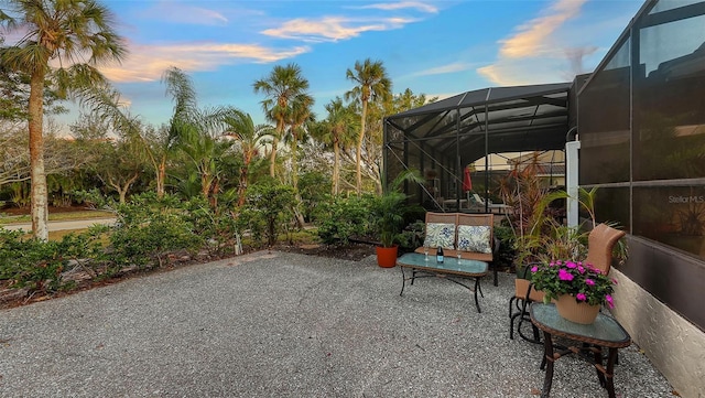 patio terrace at dusk featuring a lanai