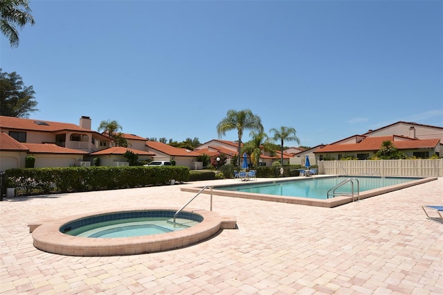 view of pool with a community hot tub and a patio area