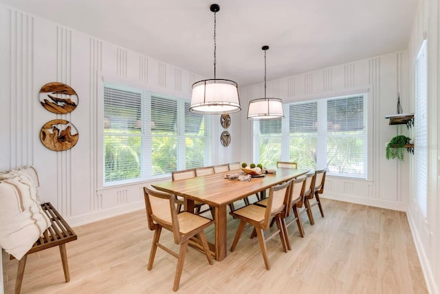 dining space featuring light hardwood / wood-style flooring and a healthy amount of sunlight