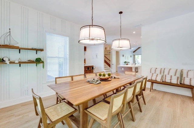 dining space featuring sink, a wealth of natural light, and light hardwood / wood-style floors