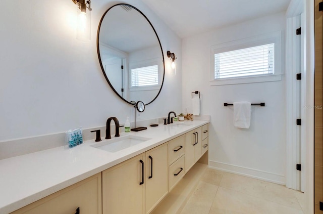 bathroom with vanity, tile patterned flooring, and a healthy amount of sunlight