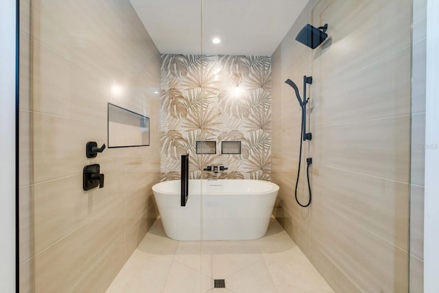 bathroom with separate shower and tub, tile walls, and tile patterned floors