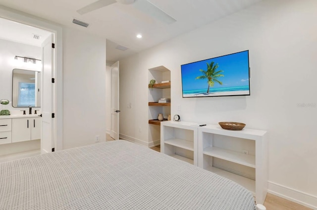 bedroom featuring connected bathroom, sink, and ceiling fan