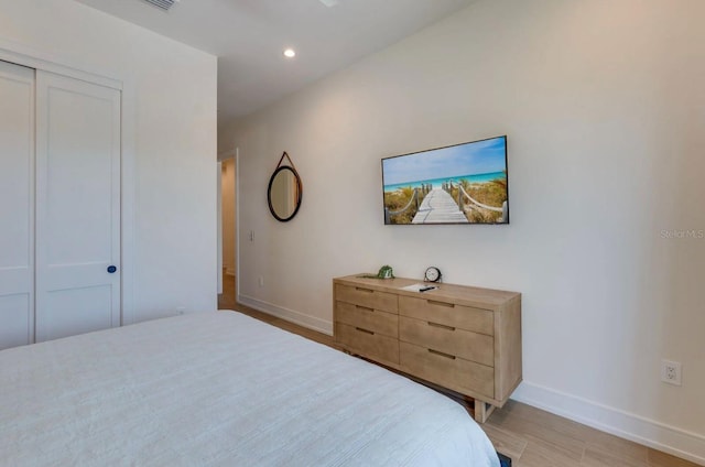 bedroom featuring light hardwood / wood-style floors and a closet