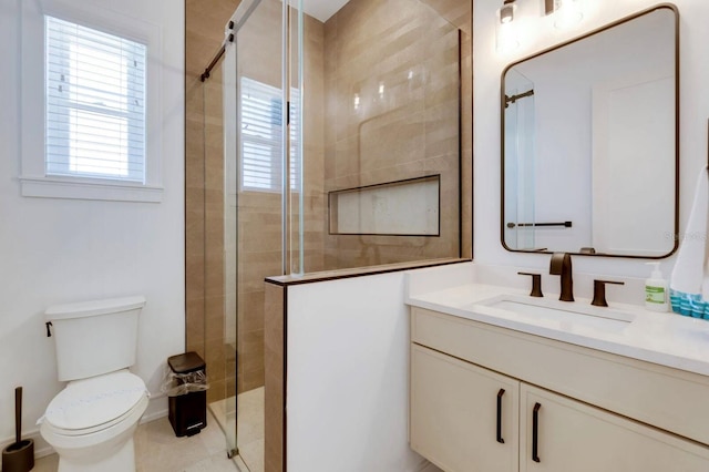 bathroom featuring vanity, toilet, and a shower with shower door