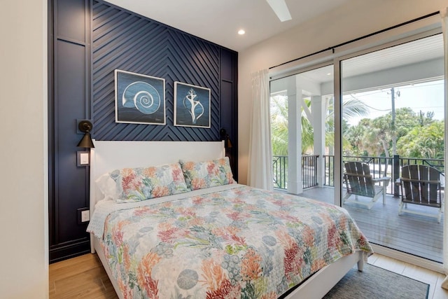 bedroom featuring light hardwood / wood-style flooring and access to outside