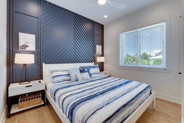 bedroom with light hardwood / wood-style flooring and ceiling fan