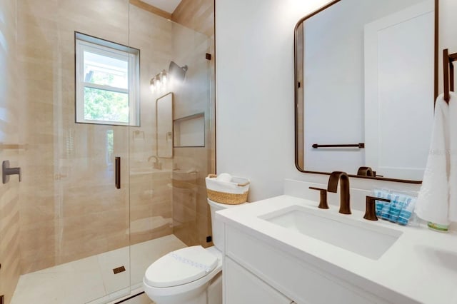 bathroom featuring an enclosed shower, vanity, and toilet