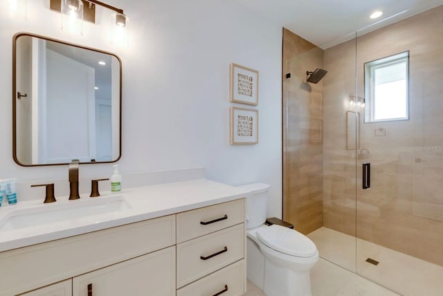 bathroom with vanity, toilet, and a shower with shower door