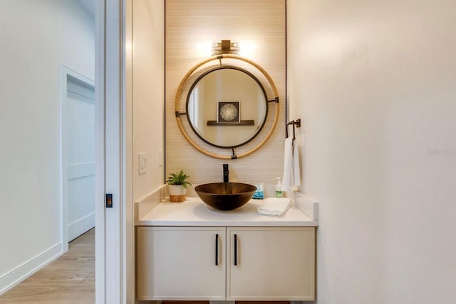 bathroom with vanity and wood-type flooring