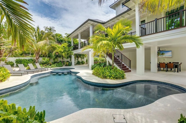 view of pool with a patio area, ceiling fan, and an in ground hot tub