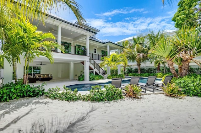 view of swimming pool with outdoor lounge area, a patio, and ceiling fan