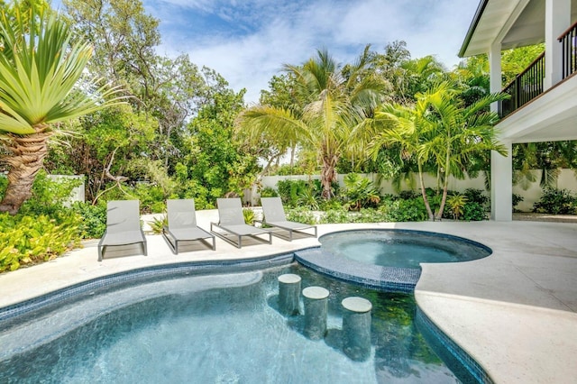 view of swimming pool with a patio and an in ground hot tub