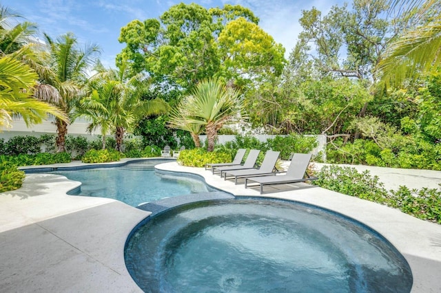 view of swimming pool with a patio and an in ground hot tub