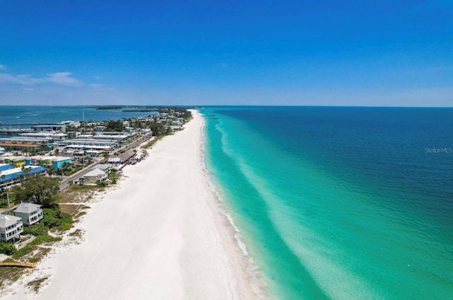 bird's eye view featuring a water view and a beach view