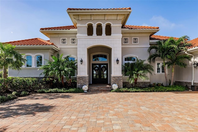 mediterranean / spanish-style home with french doors