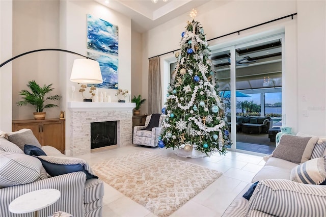 living room with a fireplace and light tile patterned floors