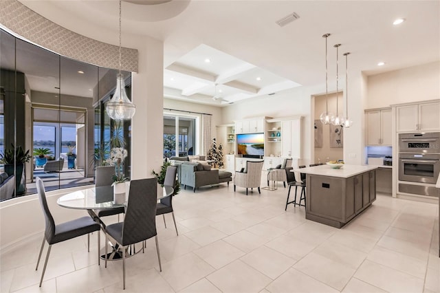 tiled dining space featuring beamed ceiling and coffered ceiling