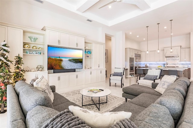 living room featuring ceiling fan and sink