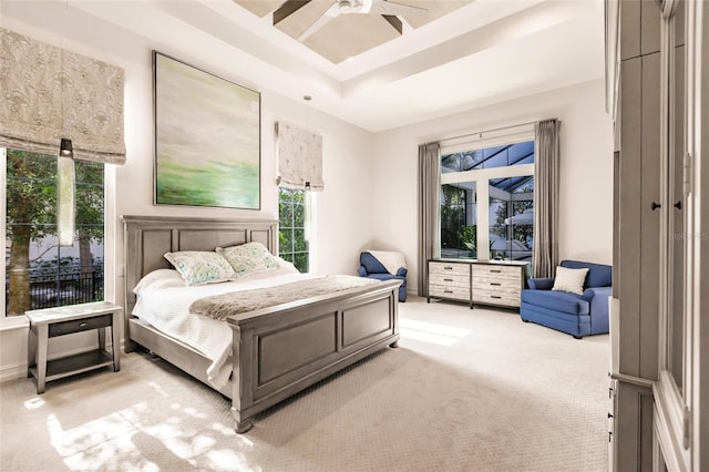 carpeted bedroom featuring multiple windows and ceiling fan