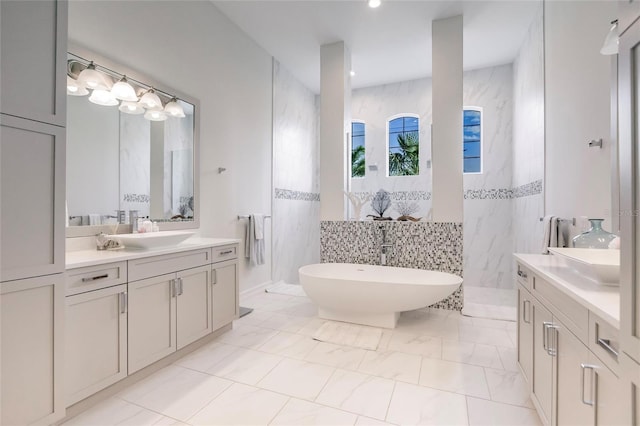 bathroom featuring shower with separate bathtub, vanity, and tile walls