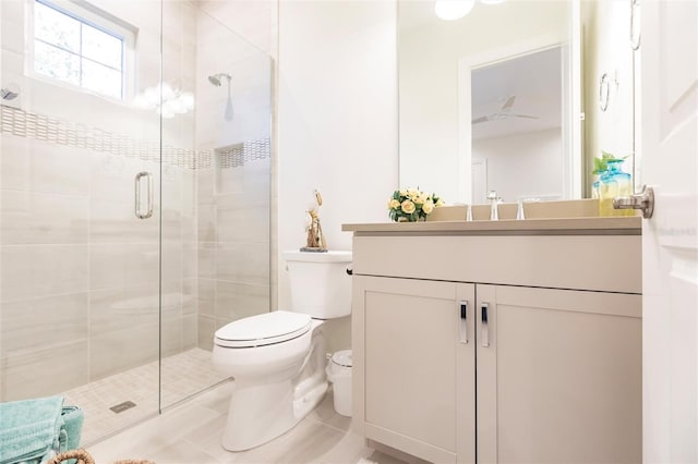 bathroom featuring tile patterned flooring, vanity, toilet, and an enclosed shower