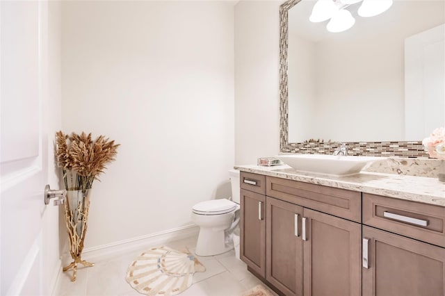 bathroom featuring tile patterned flooring, vanity, and toilet