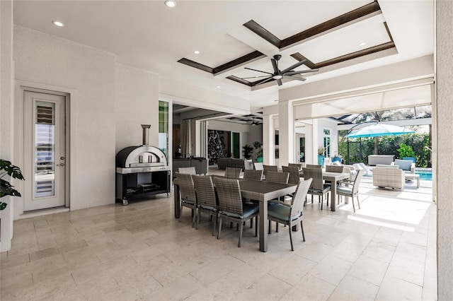 dining area with ceiling fan, beamed ceiling, and coffered ceiling