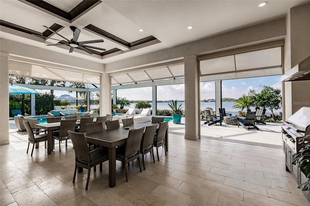 dining area with beamed ceiling, a water view, ceiling fan, and coffered ceiling