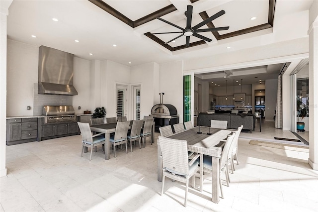 dining area featuring ceiling fan and coffered ceiling