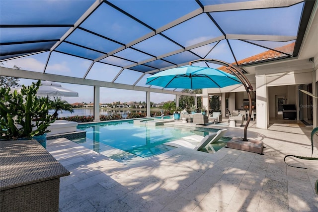 view of pool with glass enclosure, a water view, and a patio