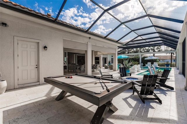 view of patio with glass enclosure and a pool