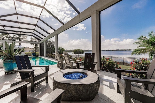 view of pool with a fire pit, a patio area, and a water view