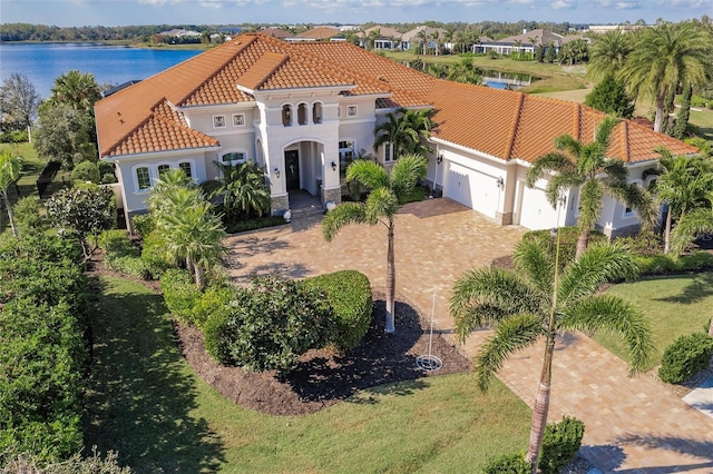 view of front facade featuring a water view and a garage