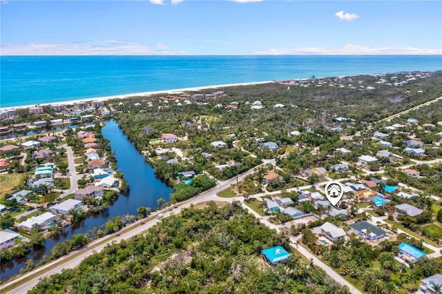 drone / aerial view featuring a water view and a view of the beach