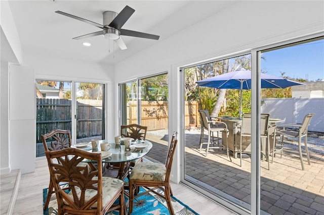 sunroom featuring ceiling fan and a wealth of natural light