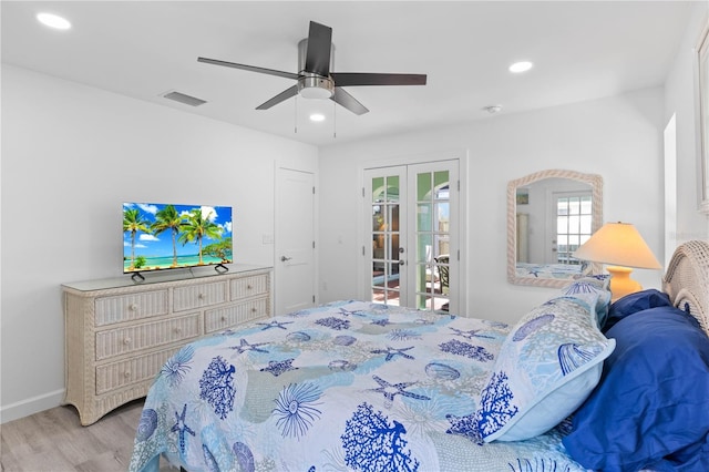 bedroom with ceiling fan, french doors, and light hardwood / wood-style floors