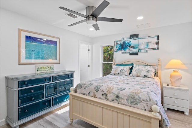 bedroom with ceiling fan and light hardwood / wood-style flooring