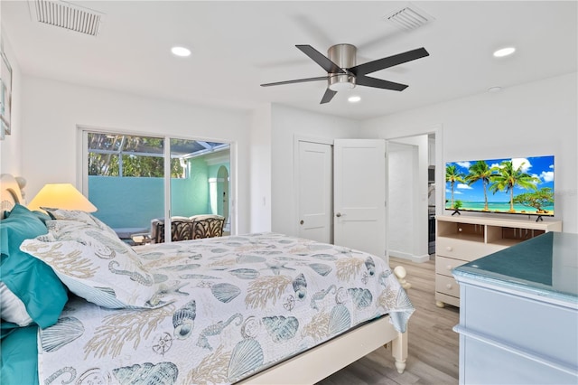 bedroom with access to exterior, ceiling fan, and wood-type flooring