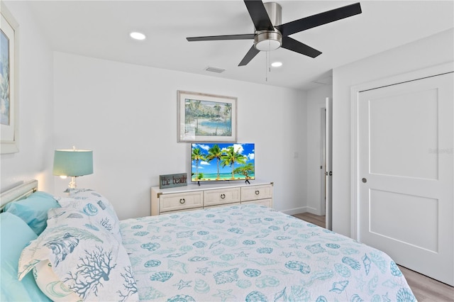 bedroom with ceiling fan and light wood-type flooring