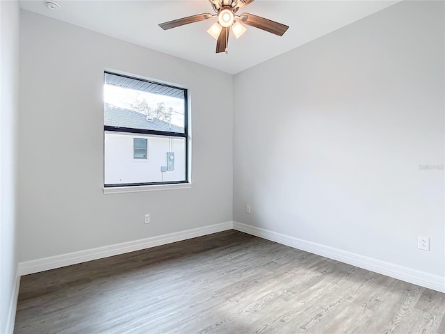 empty room with ceiling fan and wood-type flooring