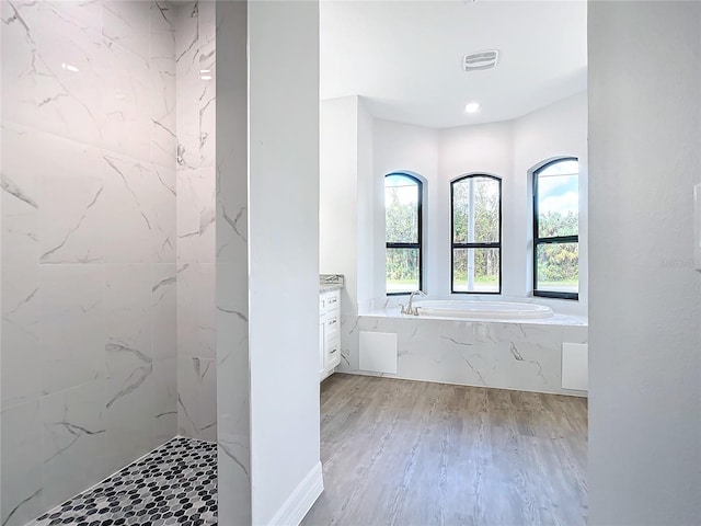 bathroom with vanity, wood-type flooring, and independent shower and bath