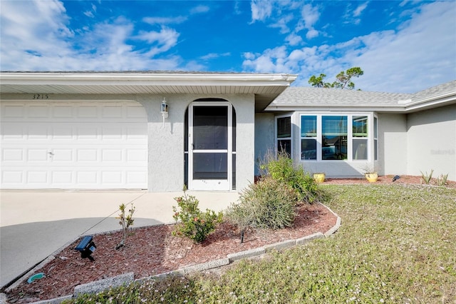 doorway to property with a lawn and a garage