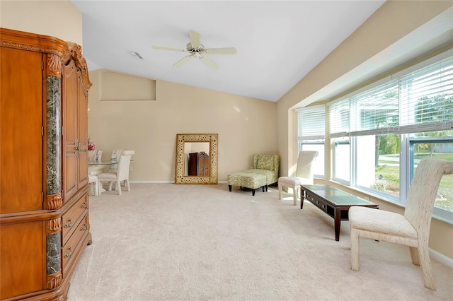 sitting room with light carpet, vaulted ceiling, and ceiling fan