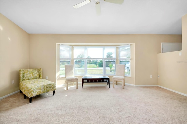 sitting room featuring ceiling fan and carpet floors