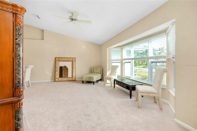 living area with carpet flooring, ceiling fan, and vaulted ceiling