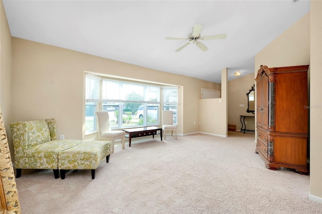 living area with light carpet, ceiling fan, and lofted ceiling